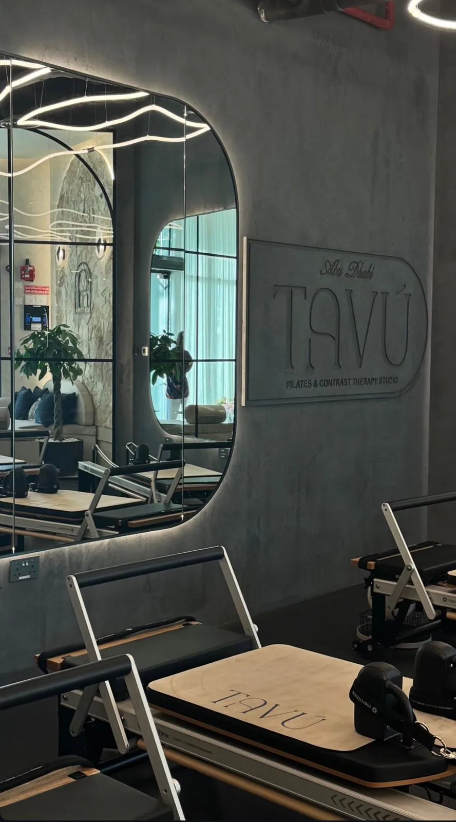 Reformer studio with TAVÚ branded wall